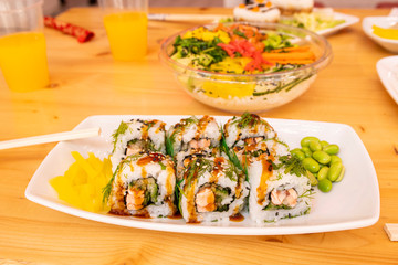 Ration of uramaki on wooden table
