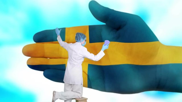 Nurse in medical mask and gloves washes large hand, painted in colors of Sweden flag. State care for nation health. Wash your hands concept. Viruses protection. Diseases prevention.