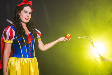 Woman dressed as fairytale character holds Radioactive atomic nuclear ionizing radiation danger...