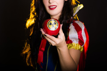 Woman dressed as fairytale character holds Radioactive atomic nuclear ionizing radiation danger...