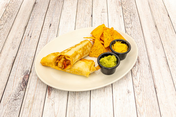 plate of fajitas with nachos and guacamole