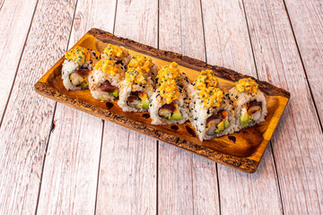 Ration of uramaki on wooden table