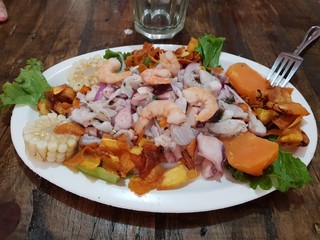 Eating a Peruvian ceviche, on a wooden table