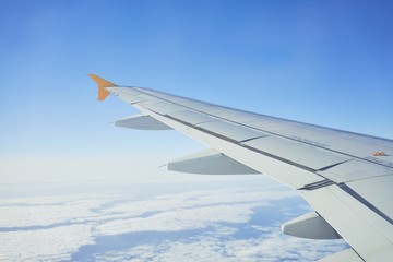 Obraz premium Cloudscape from window airplane, landscape of wing plane on a cloudy sky