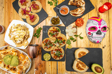 Still life with dishes of Mexican food on wooden table