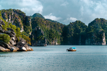 Daytime view of limestone pillars and fisherman boat at Halong, Ha Long Bay, Vietnam