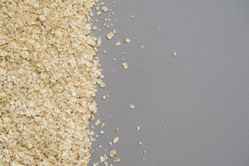 Fine grain oatmeal close up on grey background.Concept of healthy eating.