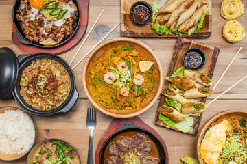 Still life with dishes of ramen and Korean food