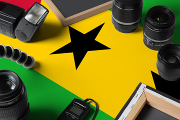 Sao Tome And Principe national flag with top view of personal photographer equipment and tools on...