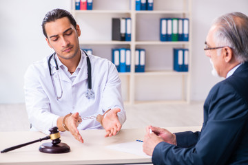 Fototapeta premium Male doctor in courthouse meeting with lawyer