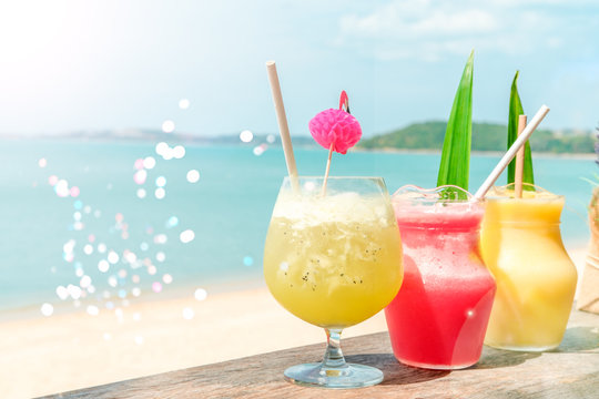 Colorful mocktails at the beach bar with sea background. Vacation, get away, summer outing concept. Bokeh effects