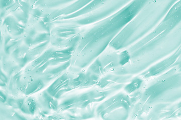 Hand sanitizer, alcohol gel, beauty serum background. Skin care clear liquid cream splash. Blue green transparent cosmetic product texture closeup - obrazy, fototapety, plakaty