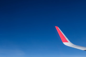 red winglet in graduated dark blue sky