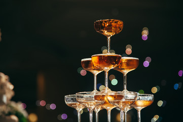 small tower of champagne's glass in wedding reception party