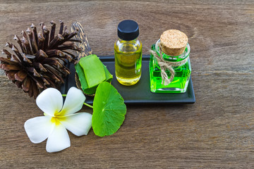 Spa herbal ( white frangipani flowers ,Aloe vera essential oil and gel,Green Asiatic Pennywort ) on wooden background