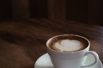 a cup of latte art on a table