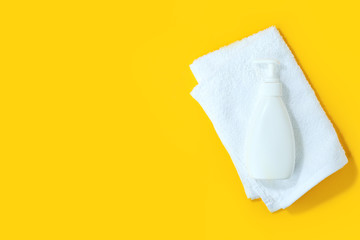 Sanitizer antiseptic gel liquid soap, white towel on yellow background. People are stocking up essentials for home quarantine. Consumer buying panic about coronavirus covid-19 concept, hygiene goods