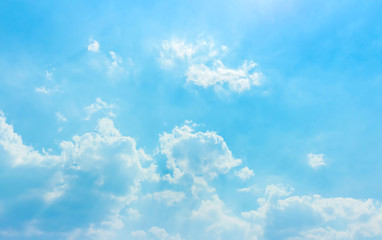 bright light with soft clouds in blue sky