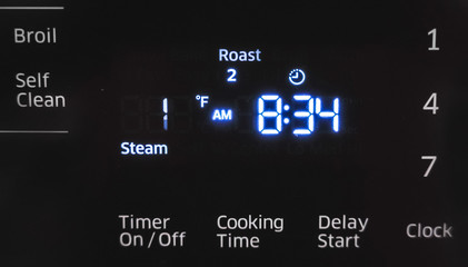 Close up of oven display flickering, control panel blinking. Electricity problem.