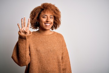 Young beautiful African American afro woman with curly hair wearing casual sweater showing and pointing up with fingers number four while smiling confident and happy.