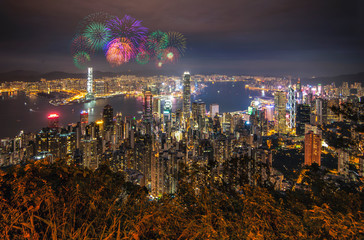 Scenic view at Night of Hong Kong Skyscraper Buildings around Victoria Harbour with Fireworks, Hong Kong