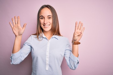 Young beautiful businesswoman wearing elegant shirt standing over isolated pink background showing...