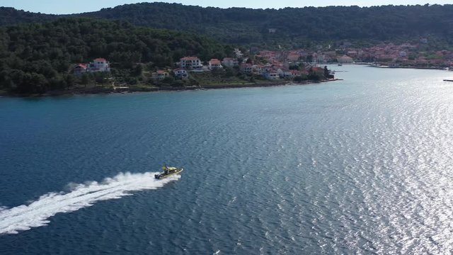 Speedboat from Coast Guard navigating into harbour - Aerial Drone View