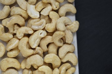 Cashew nuts on a black background.Cashew nut background.Useful fats. vegan bio product.healthy snack and dessert.	