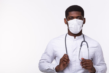 African american doctor in a mask over white background with copy space. Medicine, healthcare and people concept.