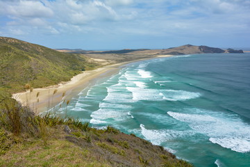Long white waves on Te Werahi Beach, New Zealand