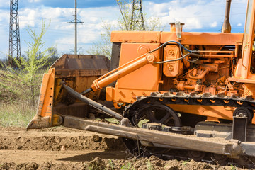 Industrial building construction site bulldozer leveling and moving soil during highway building