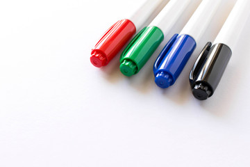 Several colored markers on a light background. Selective focus.