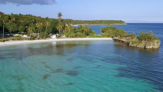 Paradise white sand beach. Calm turquoise water with palm trees. Philippines, Asia