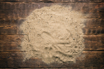 Sand on the wooden table background with copy space.