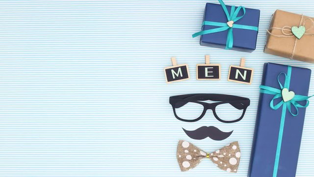 Happy men's day title appear with blue gifts - Stop motion 