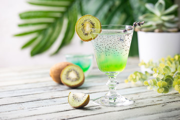 Cold cocktail kiwi drink in a glass with fresh fruits on white background