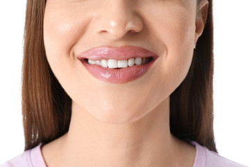 Young woman with beautiful smile on white background, closeup