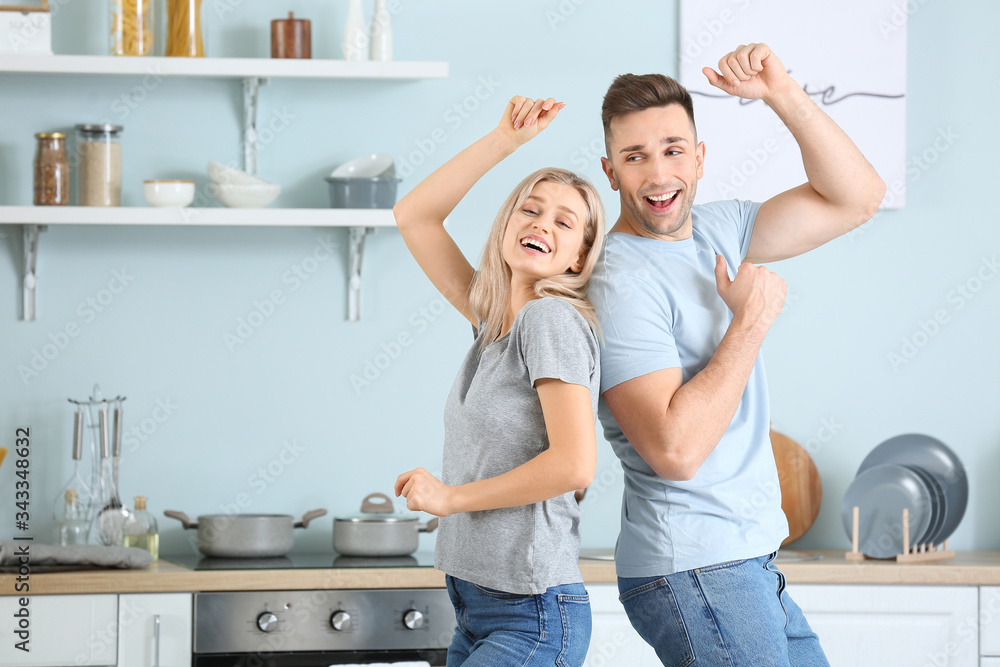 Canvas Prints Happy dancing young couple in kitchen