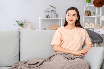 Portrait of beautiful young woman resting at home
