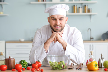 Handsome male chef in kitchen