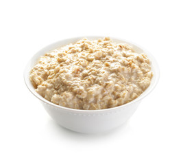 Bowl with tasty oatmeal on white background