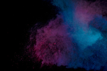 Colorful powder explosion on black background. Colorful dust explode. Paint Holi.