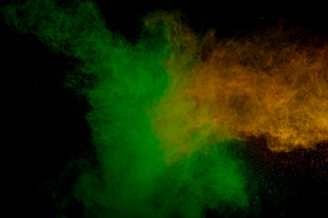 Colorful powder explosion on black background. Colorful dust explode. Paint Holi.