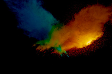 Colorful powder explosion on black background. Colorful dust explode. Paint Holi.
