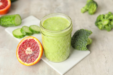 Glass of healthy smoothie and ingredients on table