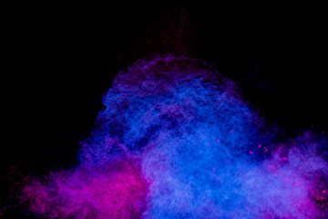 Colorful powder explosion on black background. Colorful dust explode. Paint Holi.