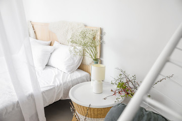 Interior of beautiful modern bedroom with spring flowers © Pixel-Shot