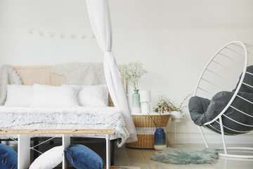 Interior of beautiful modern bedroom with spring flowers © Pixel-Shot