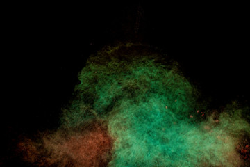 Colorful powder explosion on black background. Colorful dust explode. Paint Holi.