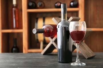 Bottle and glass of wine on table